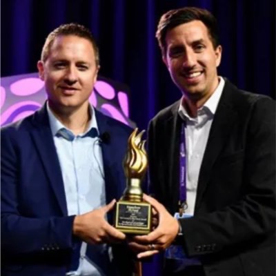 Two men holding an award together